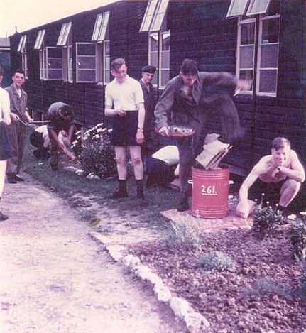 Author kneels, Graham holds shears and Colin skulks behind man in the PT kit