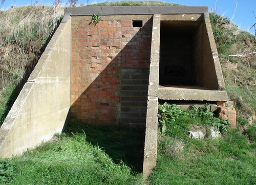 Cable portal adjacent to bricked up doorway.