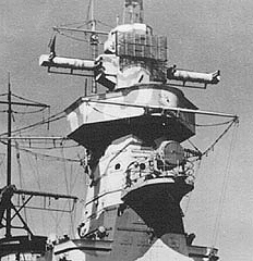 The uppermost structure is the revolvable Gun Director, the long arms being part of the original optical system. The added radar 'mattress' is clearly to be seen.